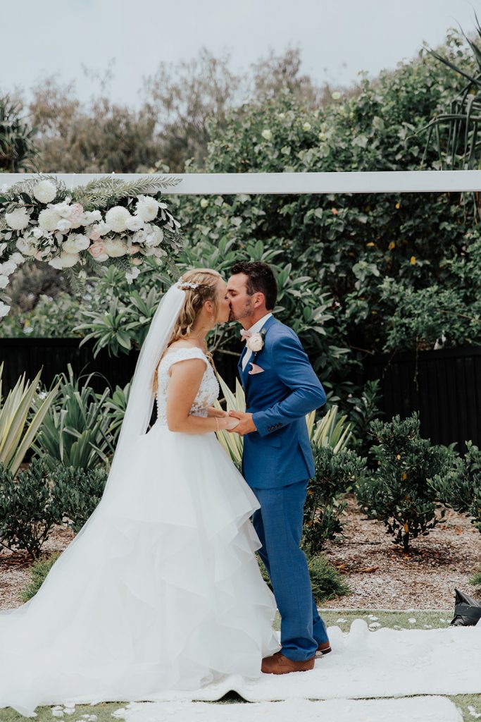 bride and groom kiss