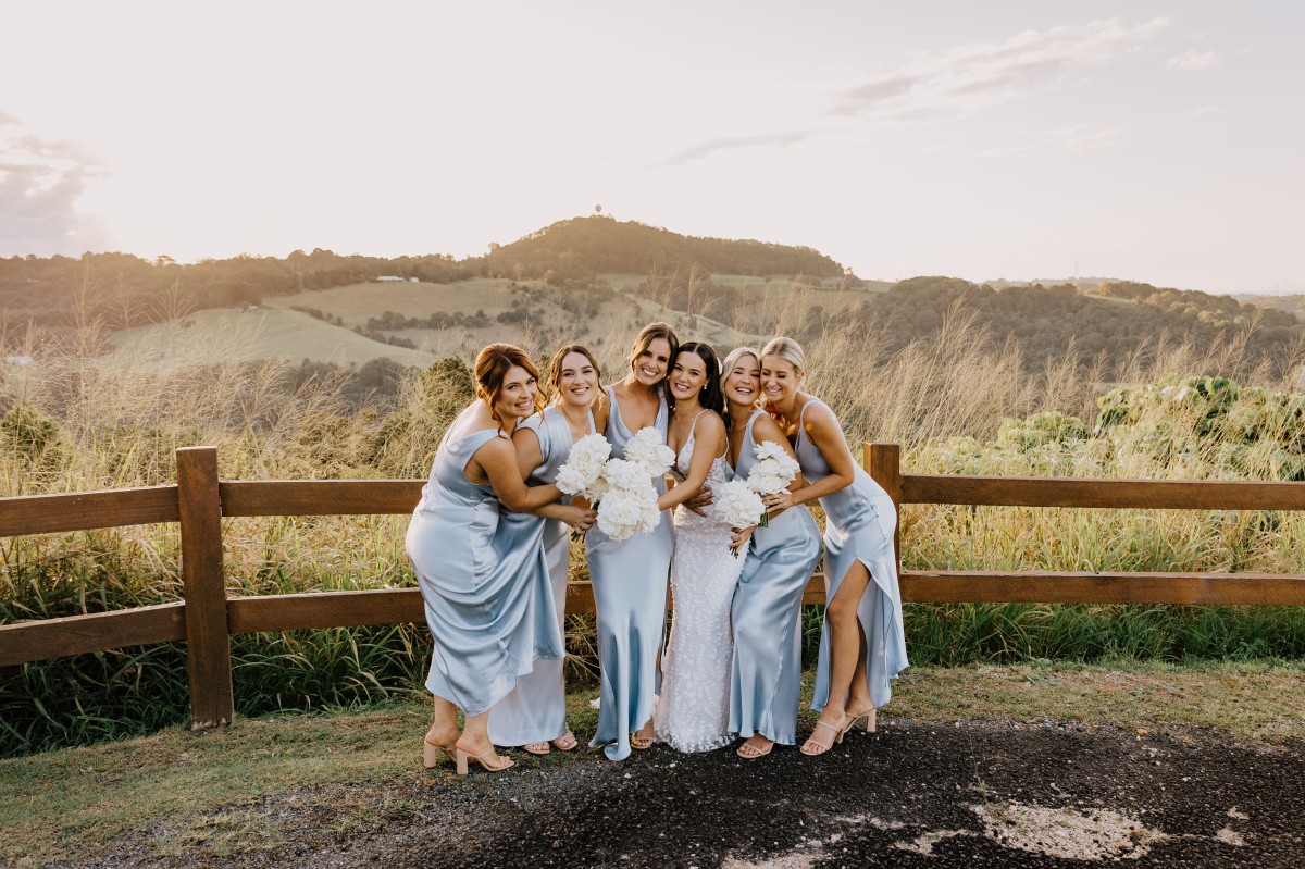 bride and bridesmaids in sky blue dresses at sunset on the Tweed Coast