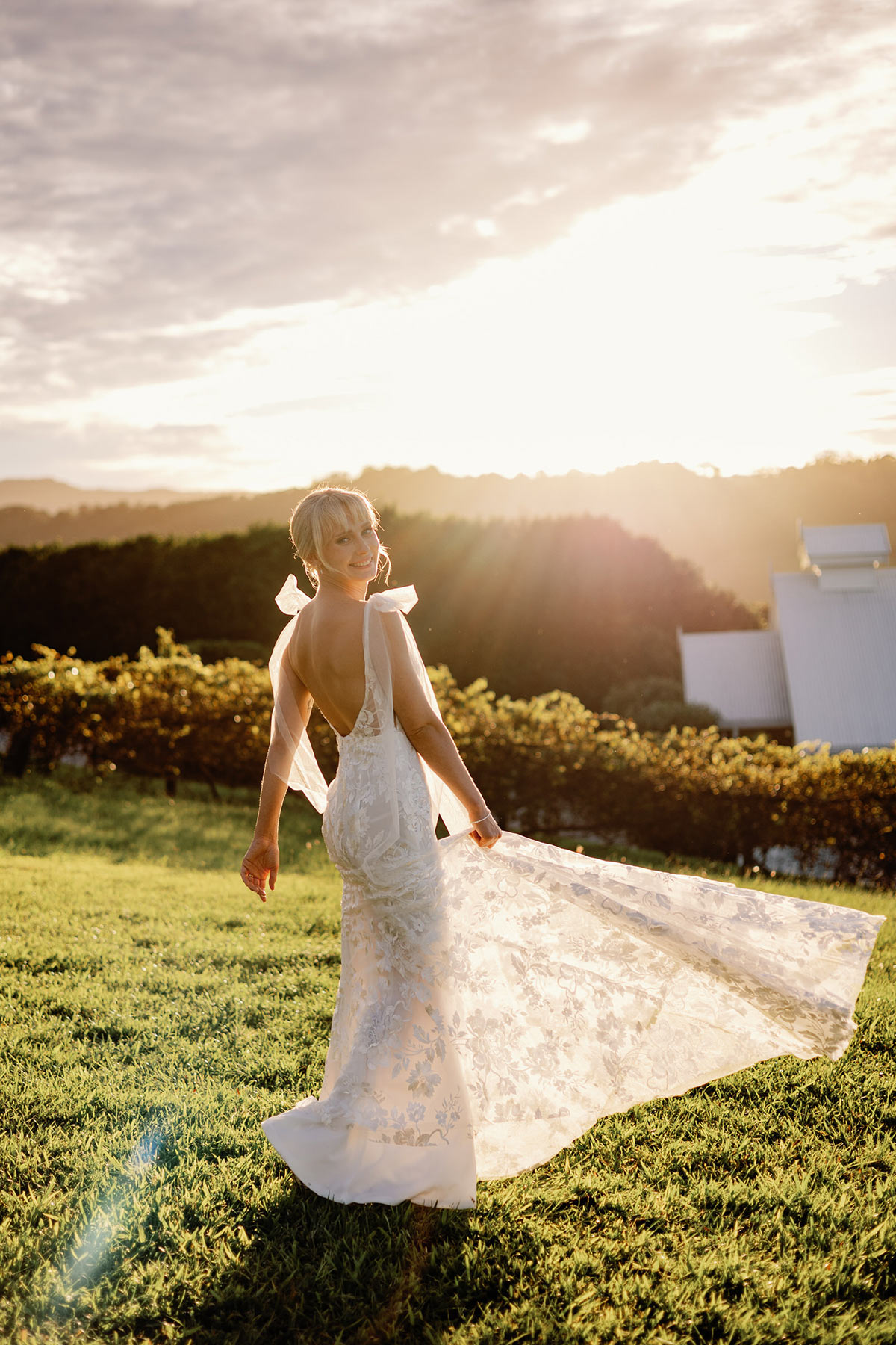 Bride dancing at sunset with dress flowing