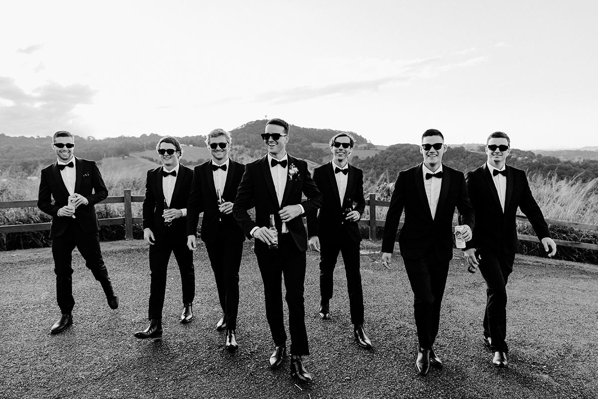 Groom and groomsman candid walking shot